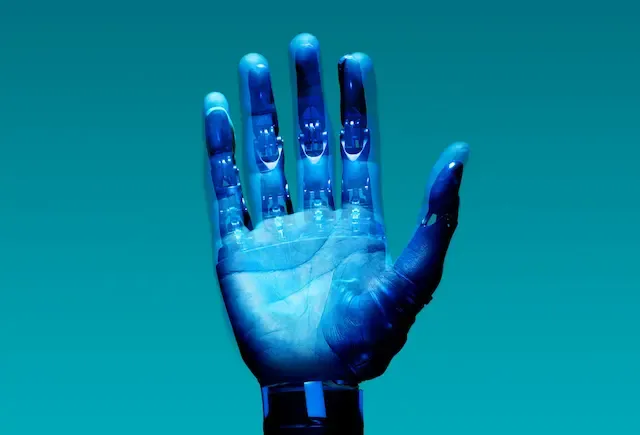 A robotic hand in front of a blue background